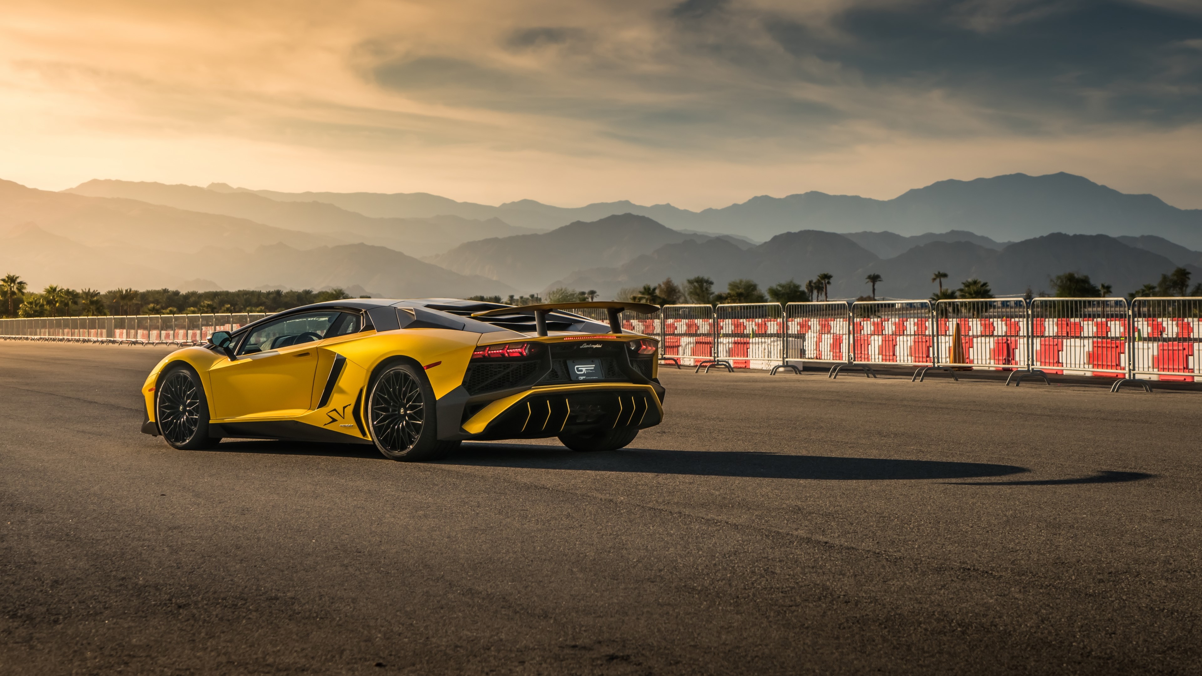 Yellow Lamborghini Aventador SV on a race track HD Wallpaper