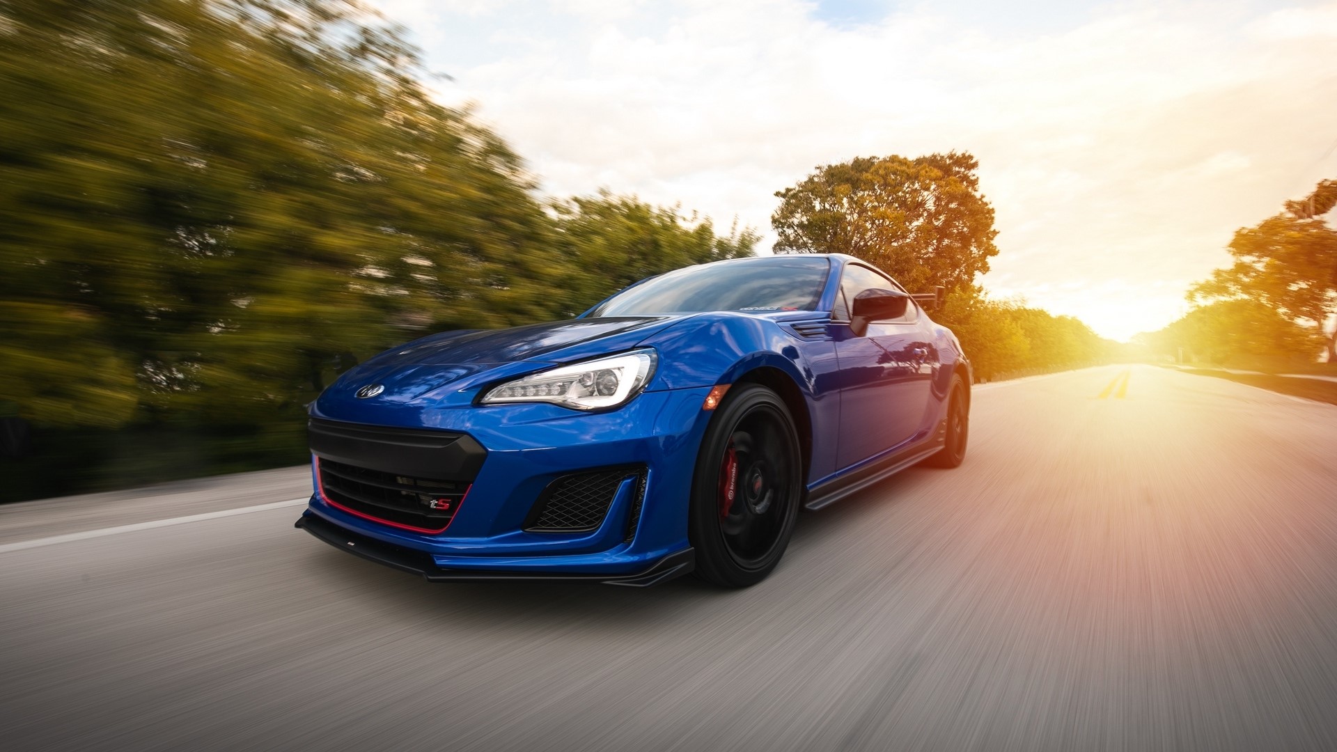 Blue Subaru BRZ driving on a road at sunset HD Wallpaper