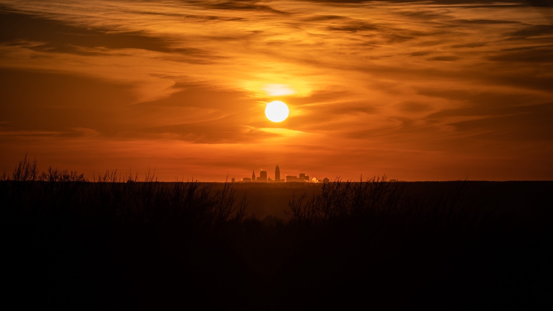 Sunset over a city skyline HD Wallpaper