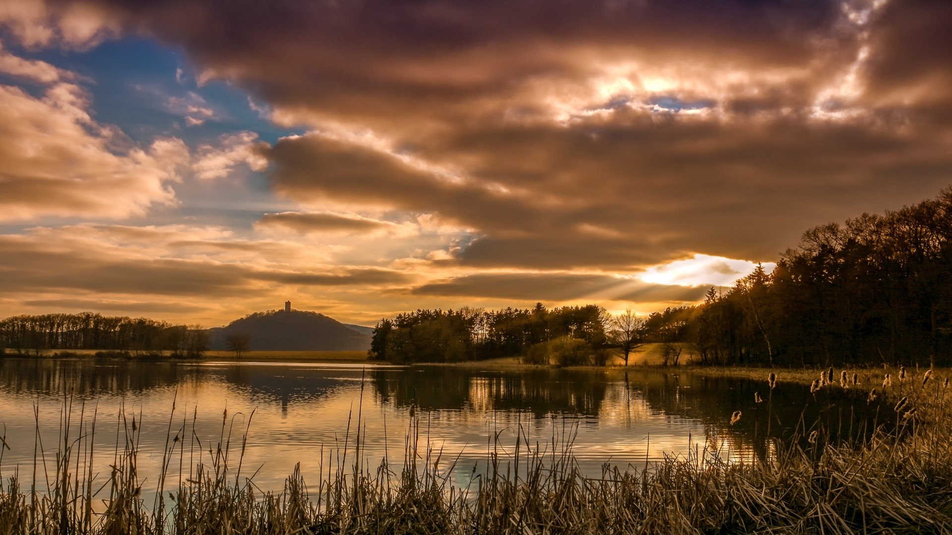 Lake and castle at sunset with dramatic clouds HD Wallpaper