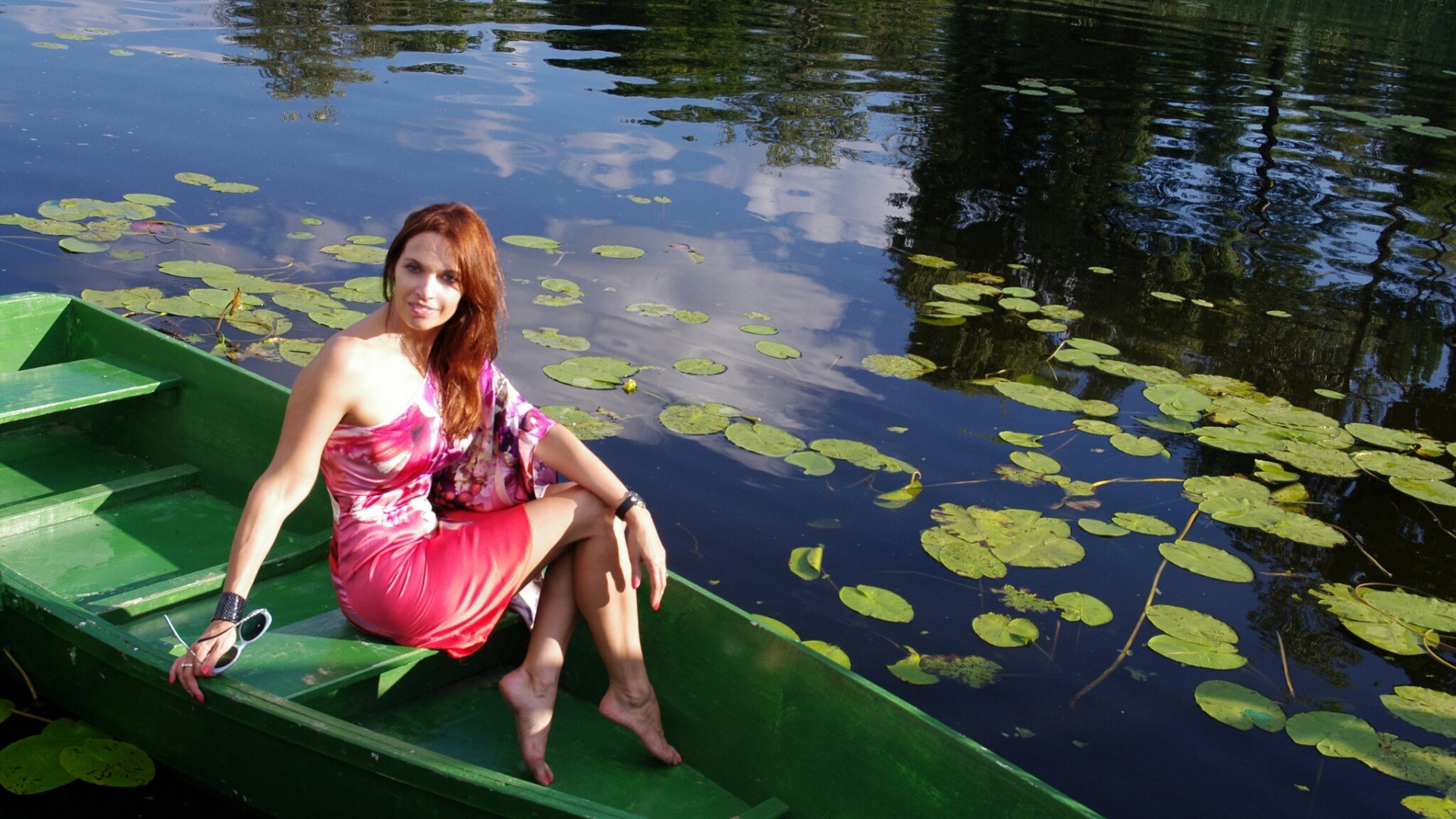 Girl in a boat on a lake with lily pads HD Wallpaper