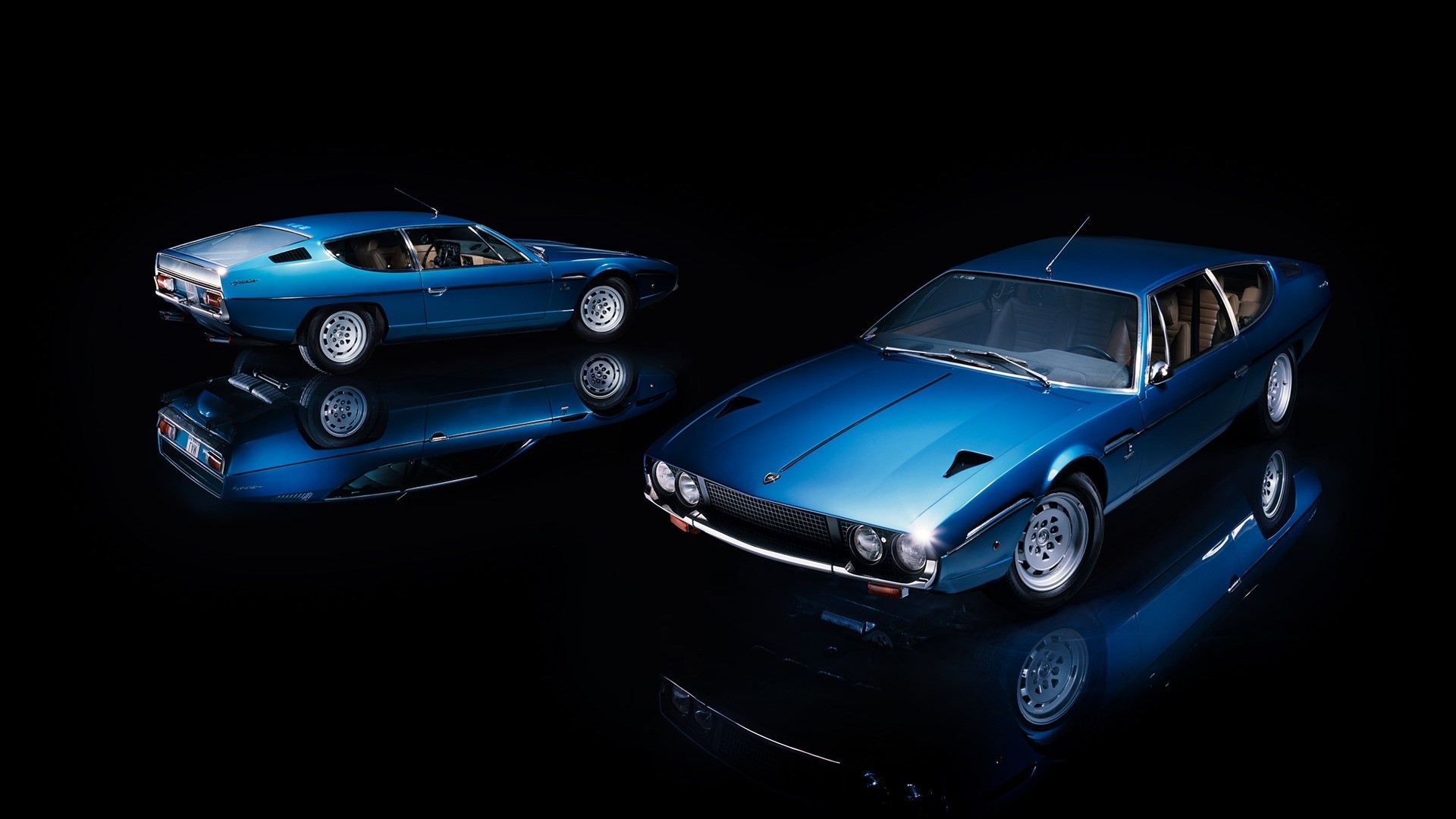 Two blue Lamborghini Espada cars on a reflective surface HD Wallpaper