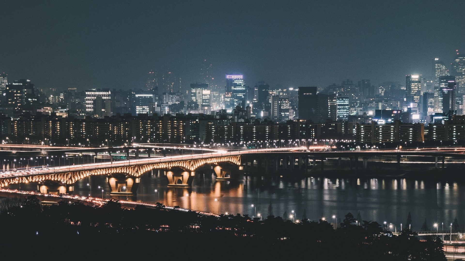 Night cityscape with illuminated bridges over a river HD Wallpaper