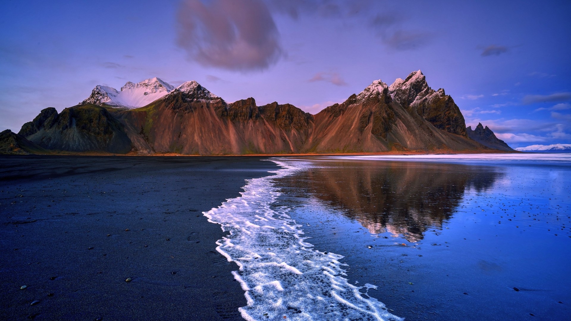 Black sand beach with mountains and sea HD Wallpaper