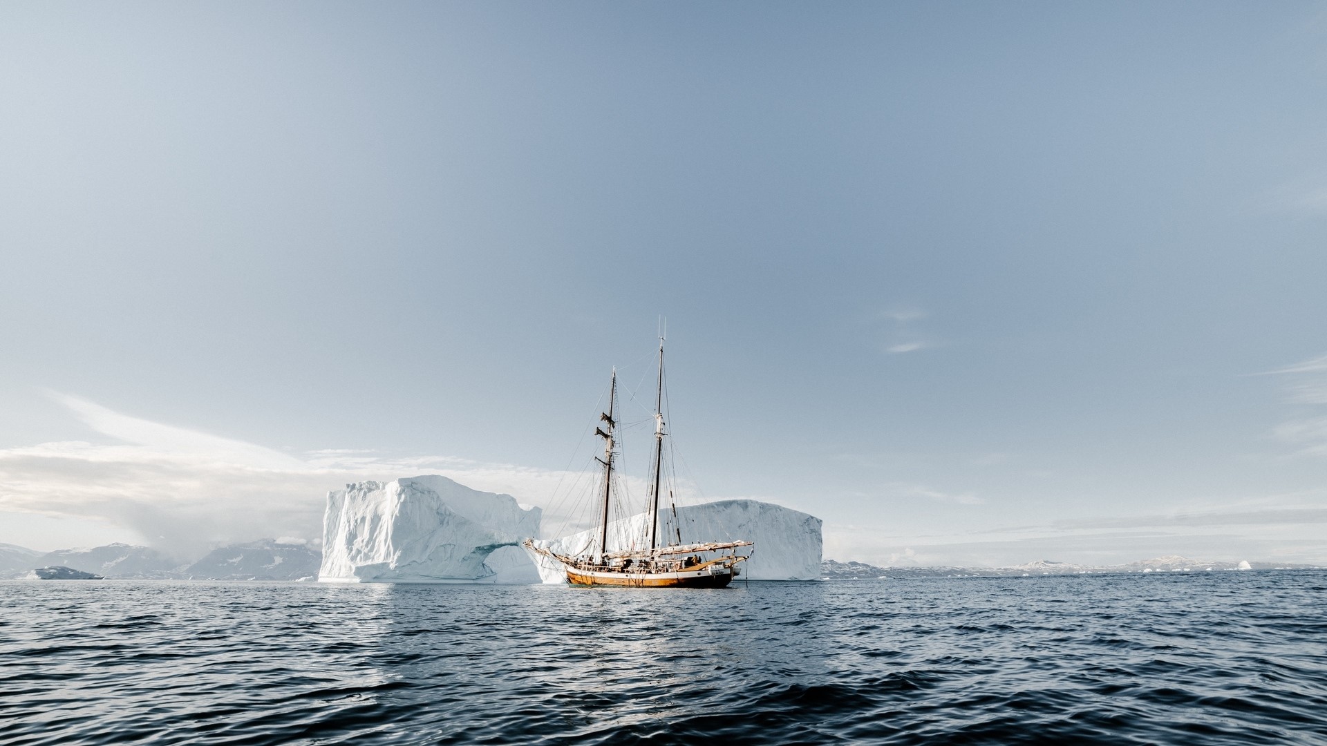 Sailboat near icebergs in the ocean HD Wallpaper