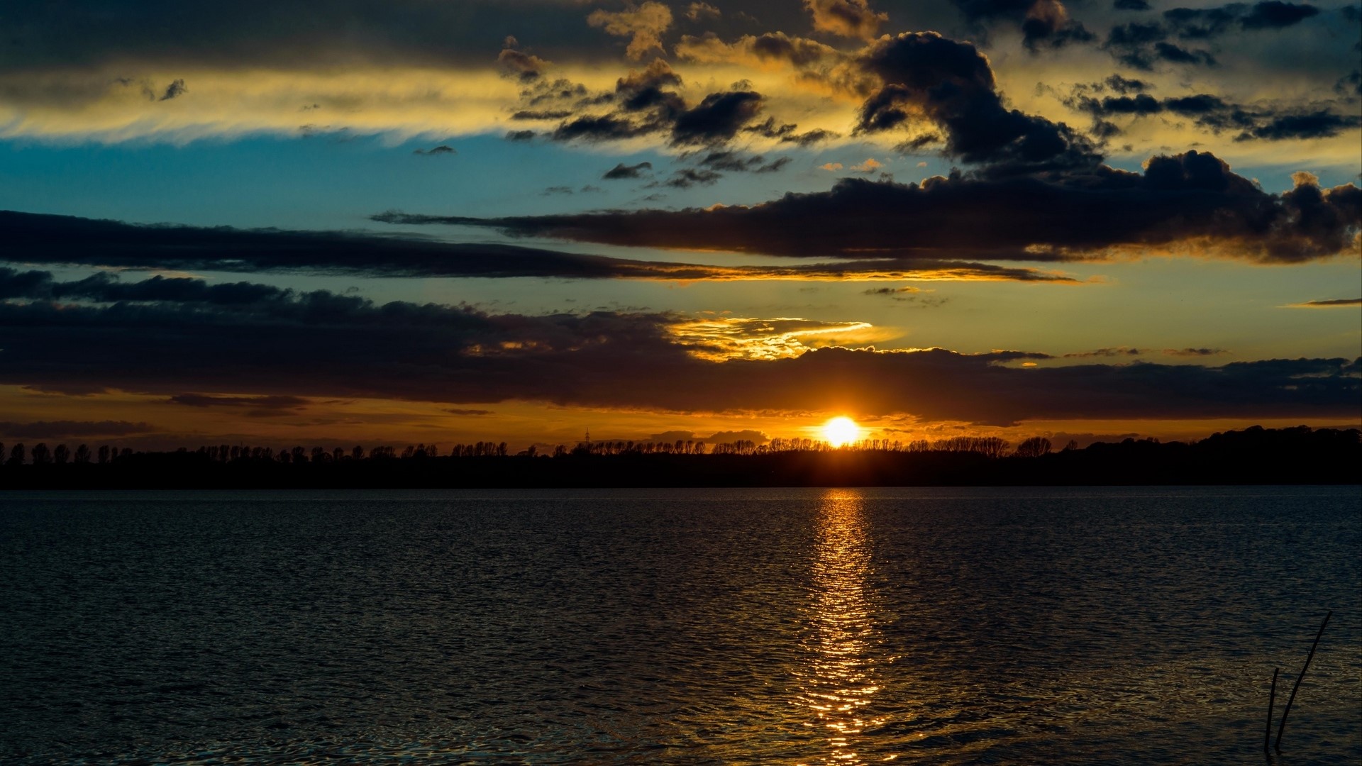 Sunset over a body of water with clouds HD Wallpaper