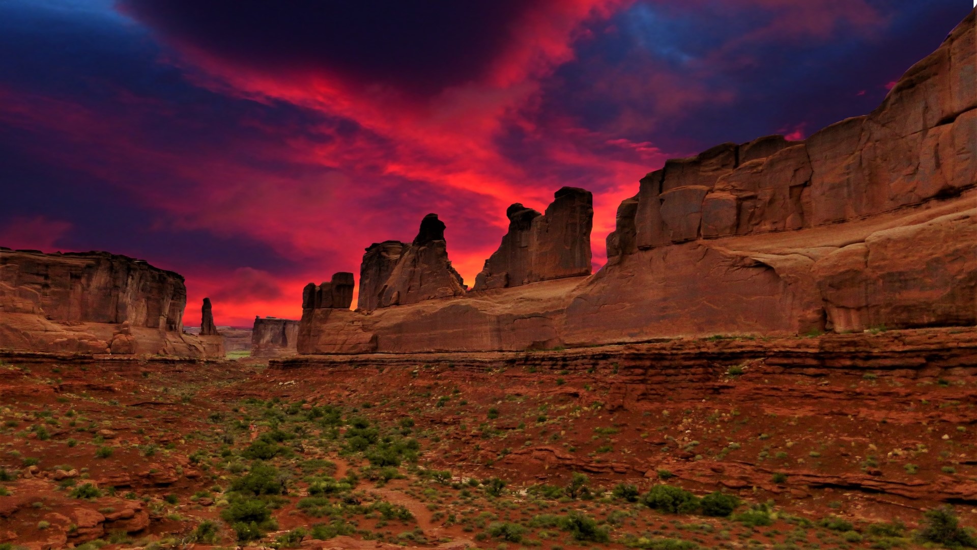 Desert landscape with red rock formations and sunset sky HD Wallpaper