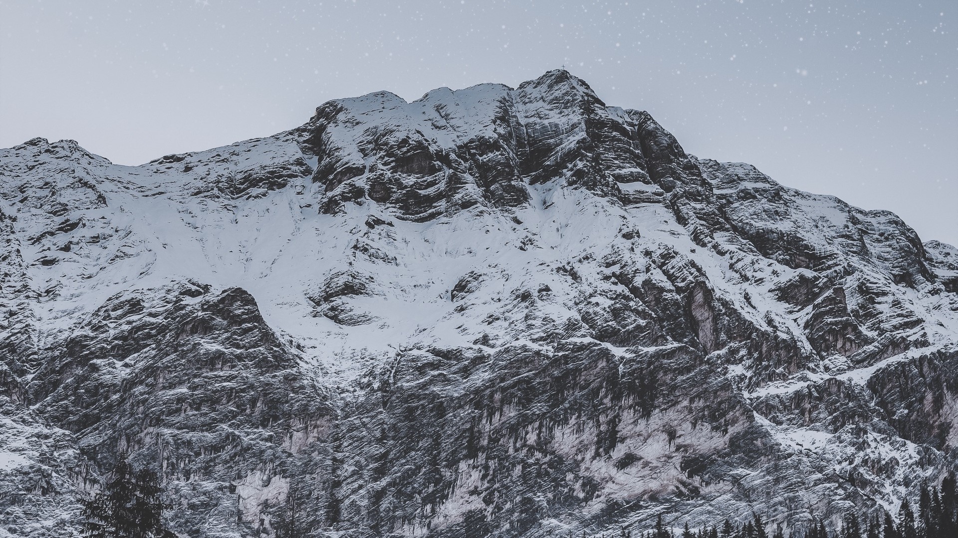 Snow-covered mountain peak under a starry sky HD Wallpaper