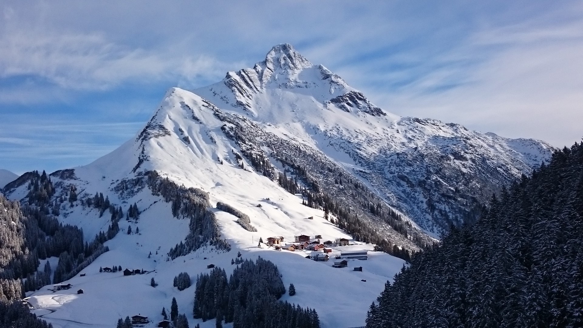 Snowy mountain landscape with village HD Wallpaper