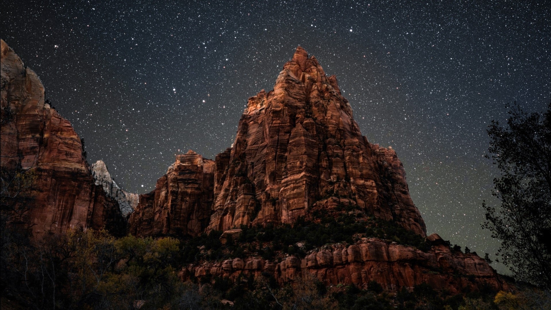 Mountain peak under a starry night sky HD Wallpaper