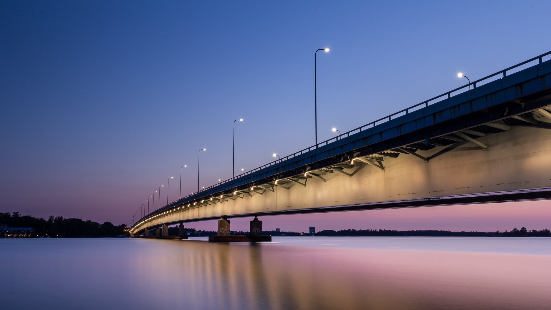 Bridge over water at dusk with lights HD Wallpaper