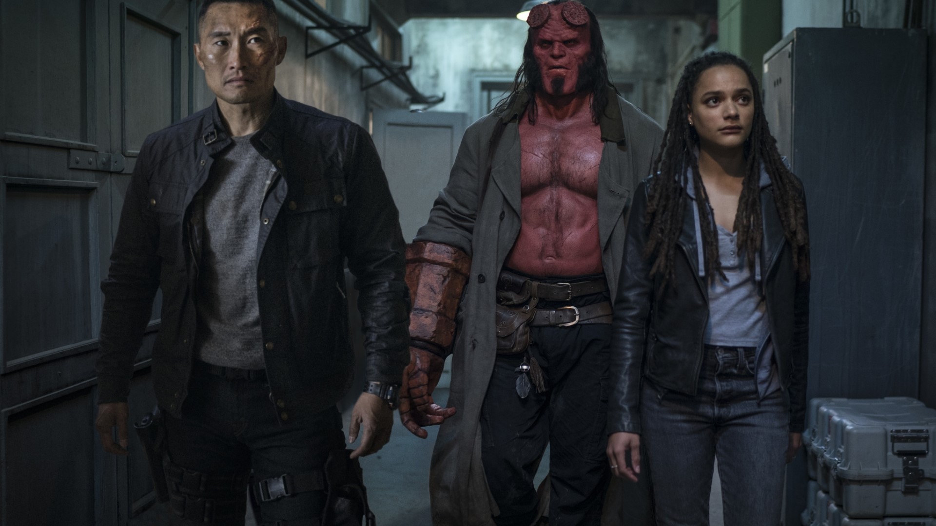 Hellboy and allies in a hallway HD Wallpaper