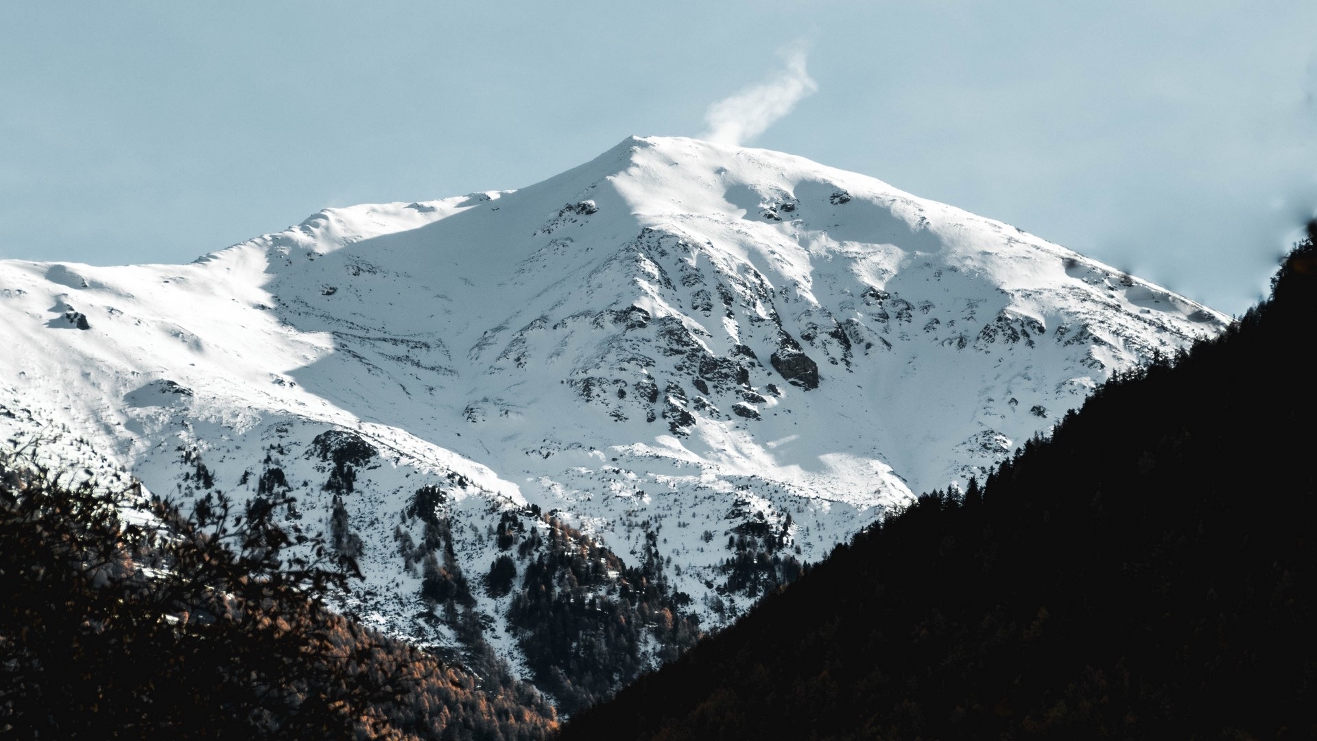 Snowy mountain peak with a plume of smoke HD Wallpaper