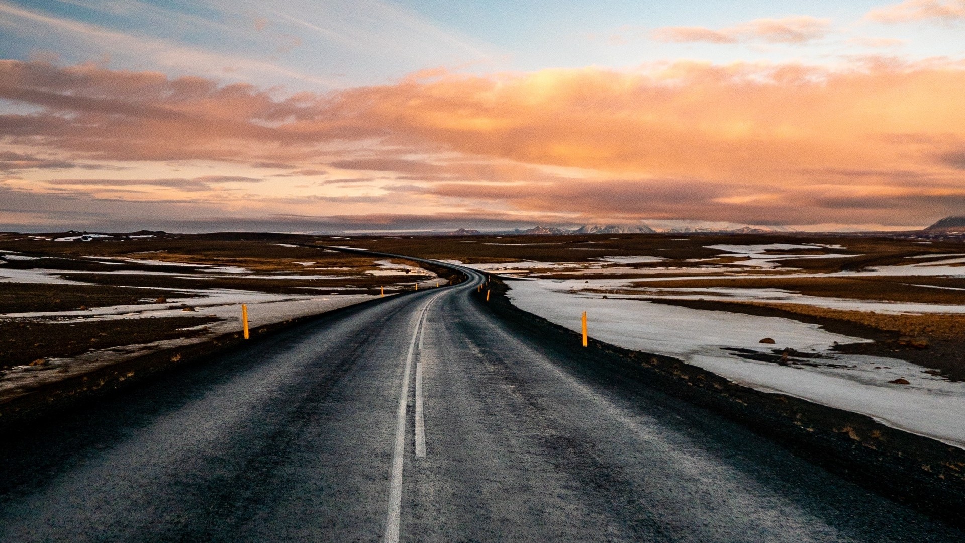 Road through a barren landscape at sunset HD Wallpaper