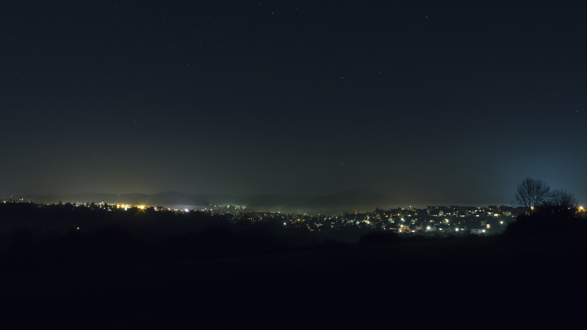 Night city lights under starry sky HD Wallpaper