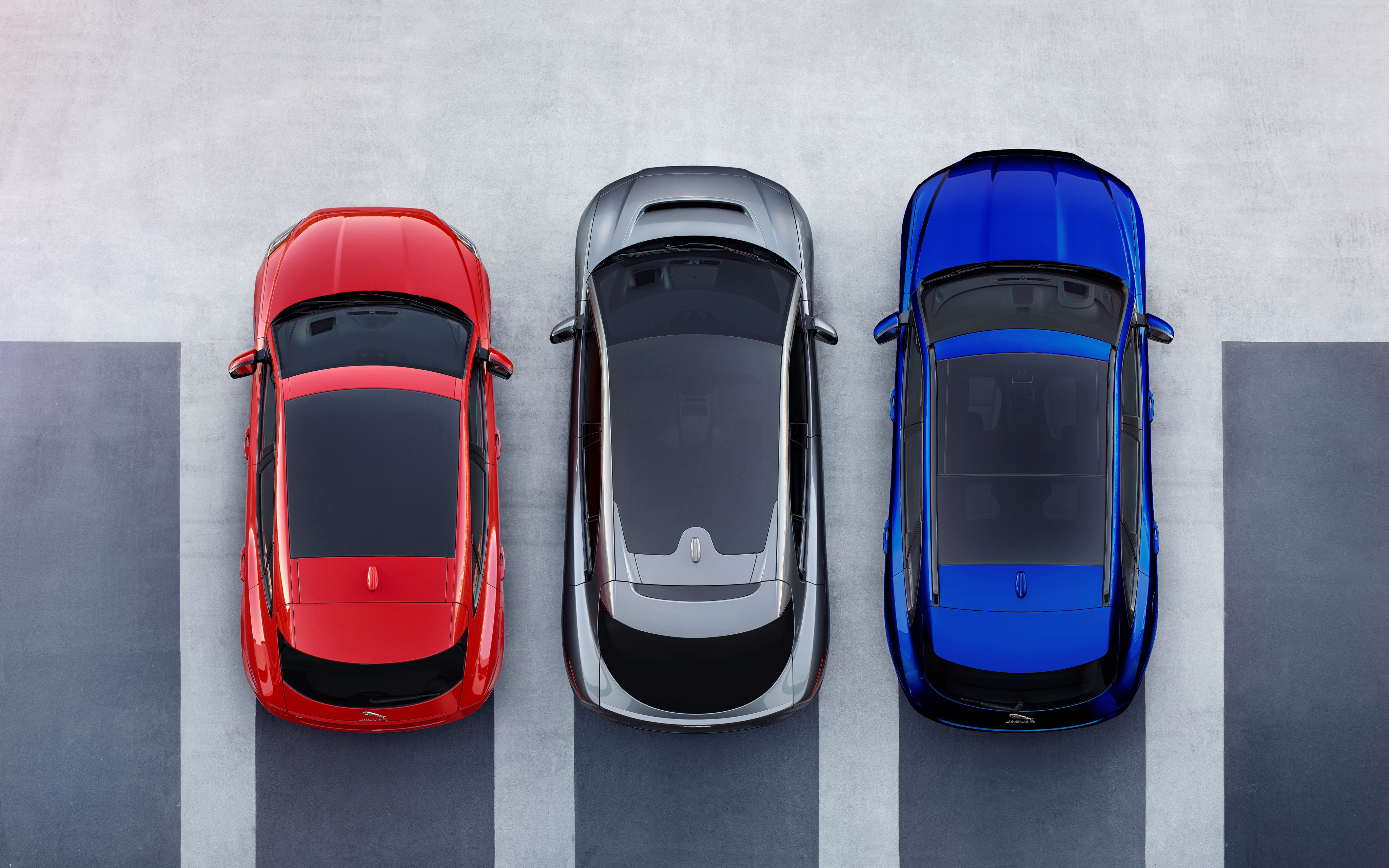 Three Jaguar SUVs parked in a lot HD Wallpaper