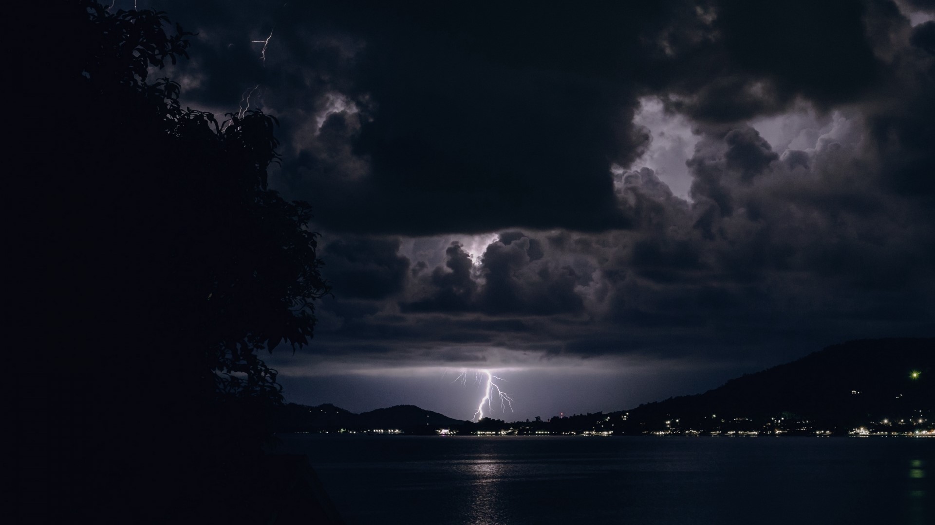Lightning strikes over a bay at night HD Wallpaper