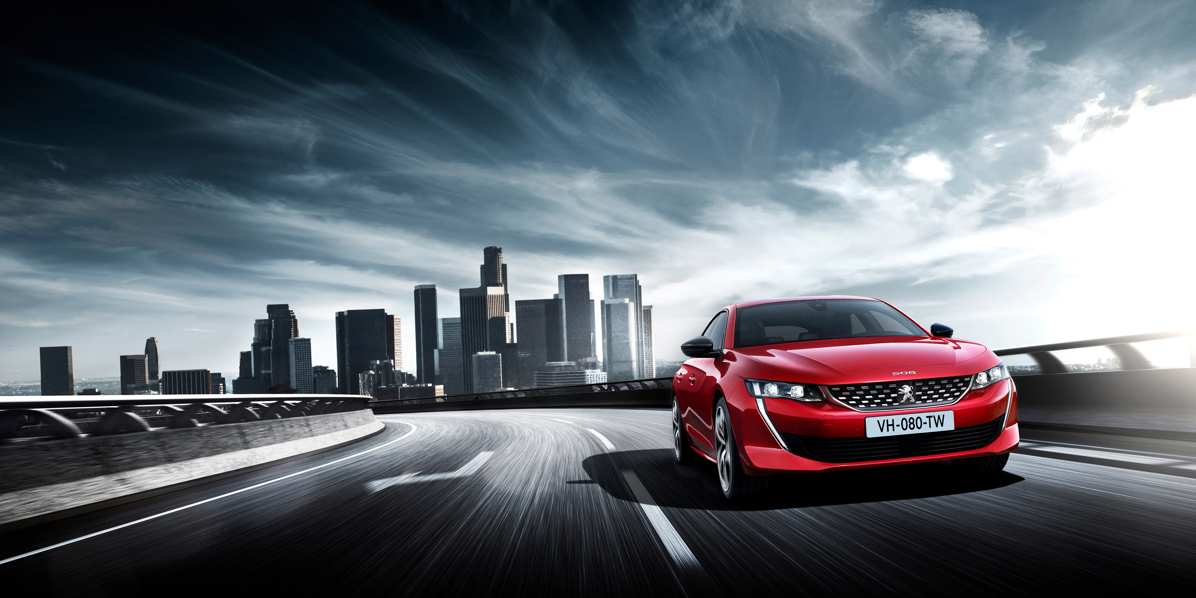 Red Peugeot 508 GT driving on a highway with city skyline HD Wallpaper