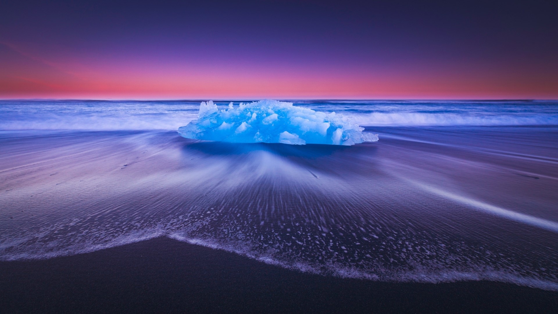 Iceberg on a beach at sunset HD Wallpaper