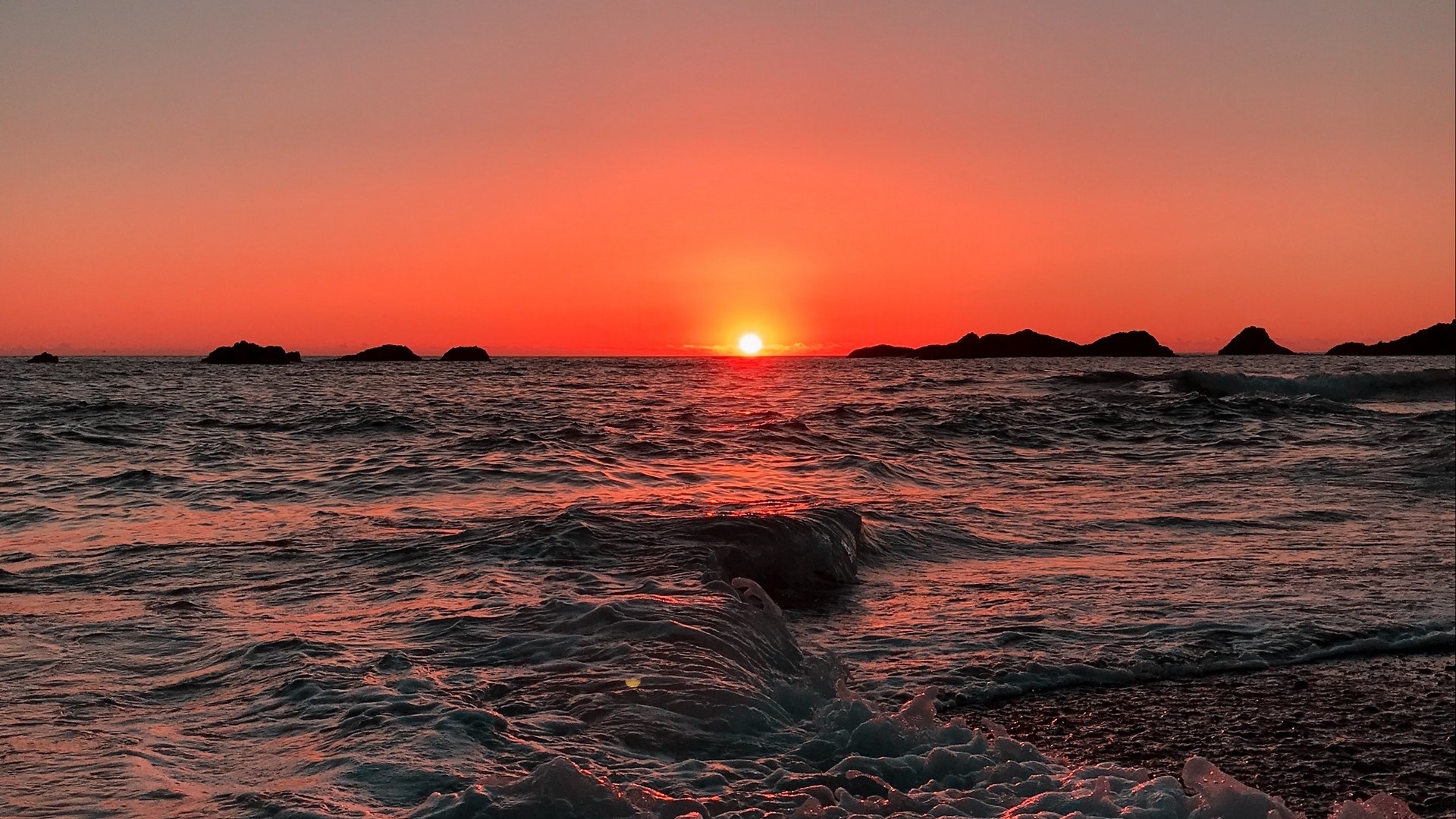 Sunset over the ocean with islands HD Wallpaper