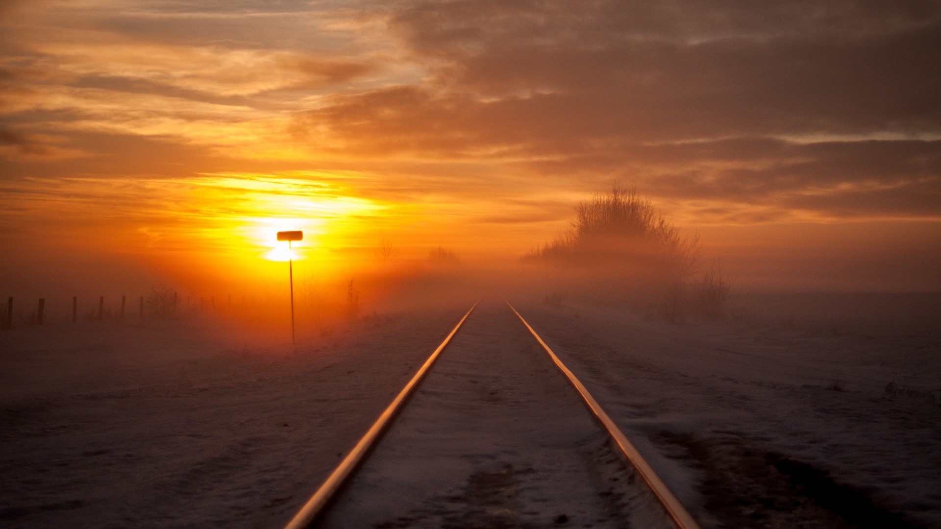 Railway tracks at sunset with fog HD Wallpaper