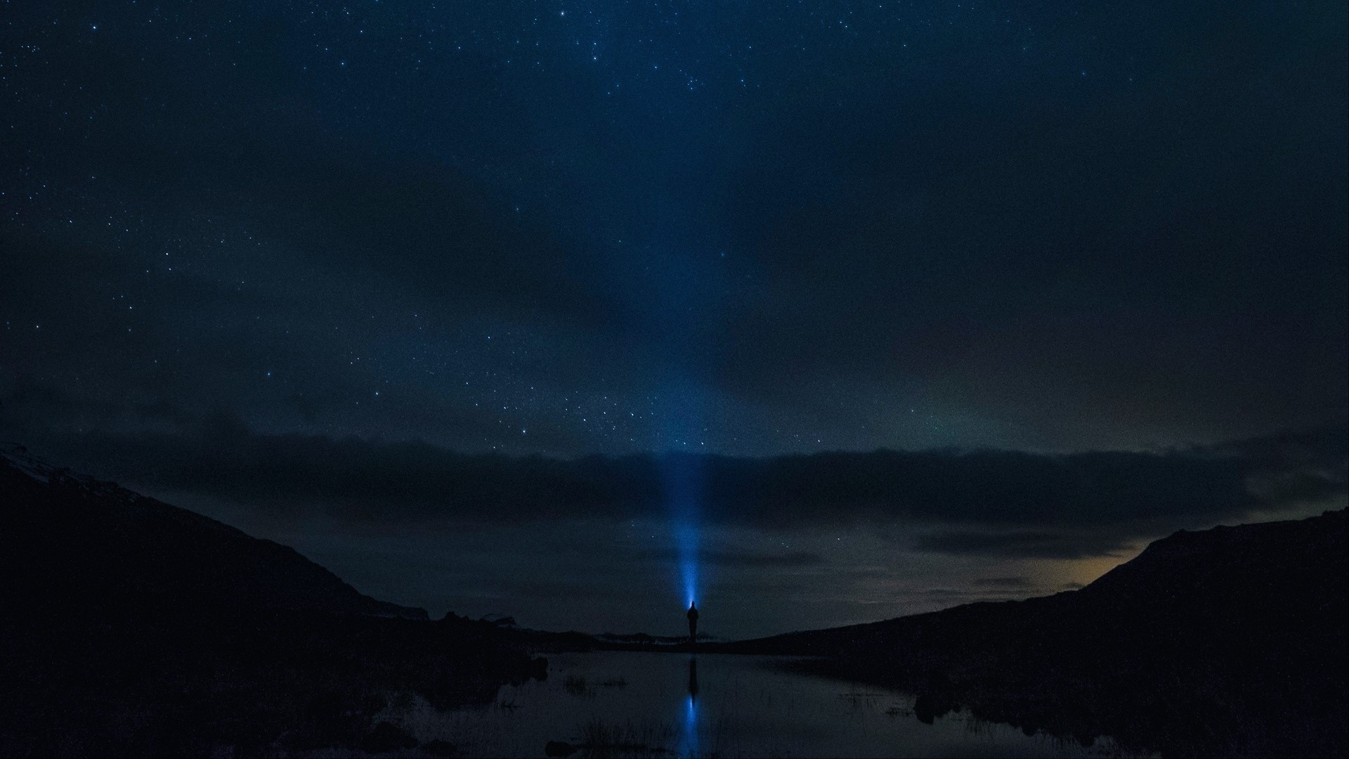 Person with flashlight under starry sky HD Wallpaper