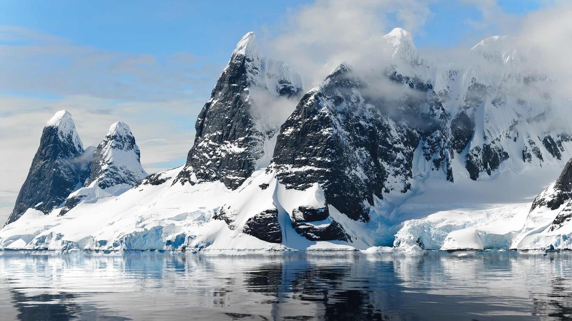 Snow-covered mountains reflected in the sea HD Wallpaper