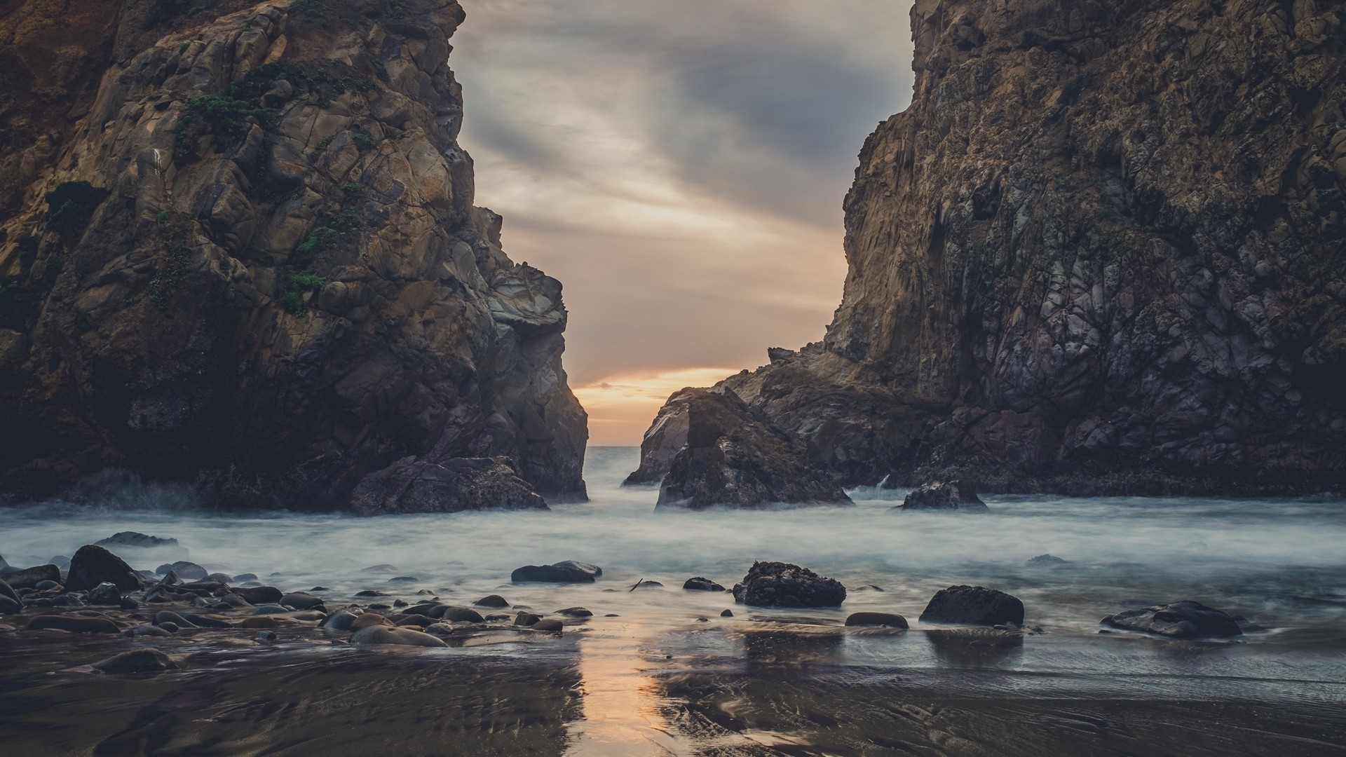 Rocky coastline with ocean waves at sunset HD Wallpaper