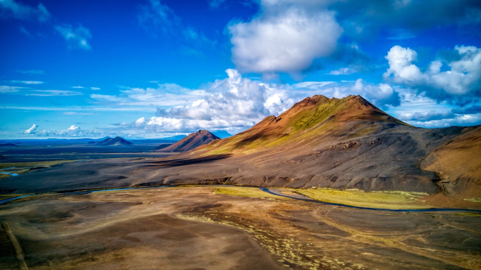 Mountains under a blue sky with clouds HD Wallpaper