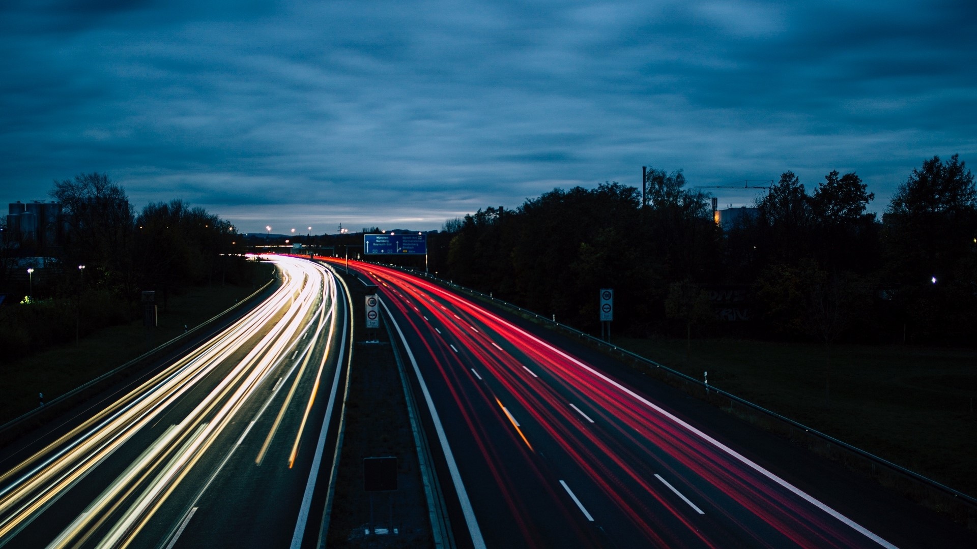 Light trails on a highway at dusk HD Wallpaper
