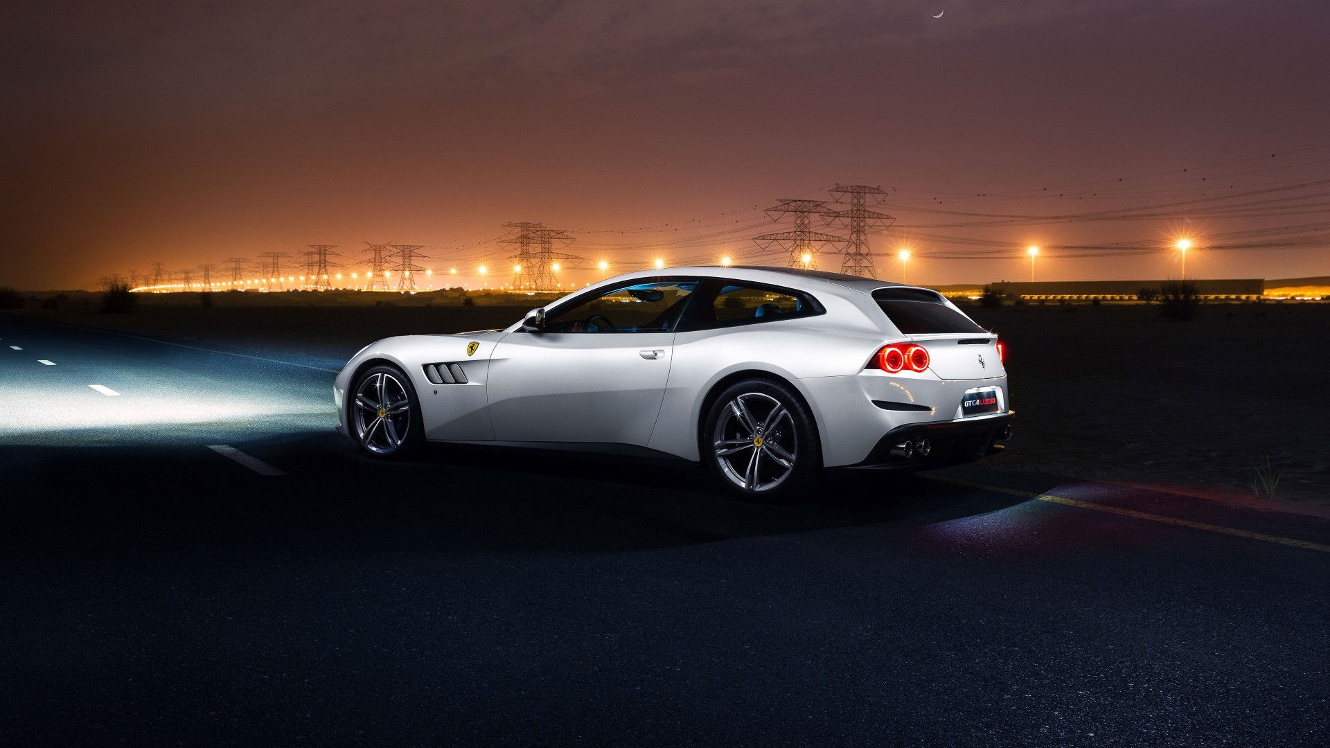 Ferrari GTC4Lusso driving at night HD Wallpaper