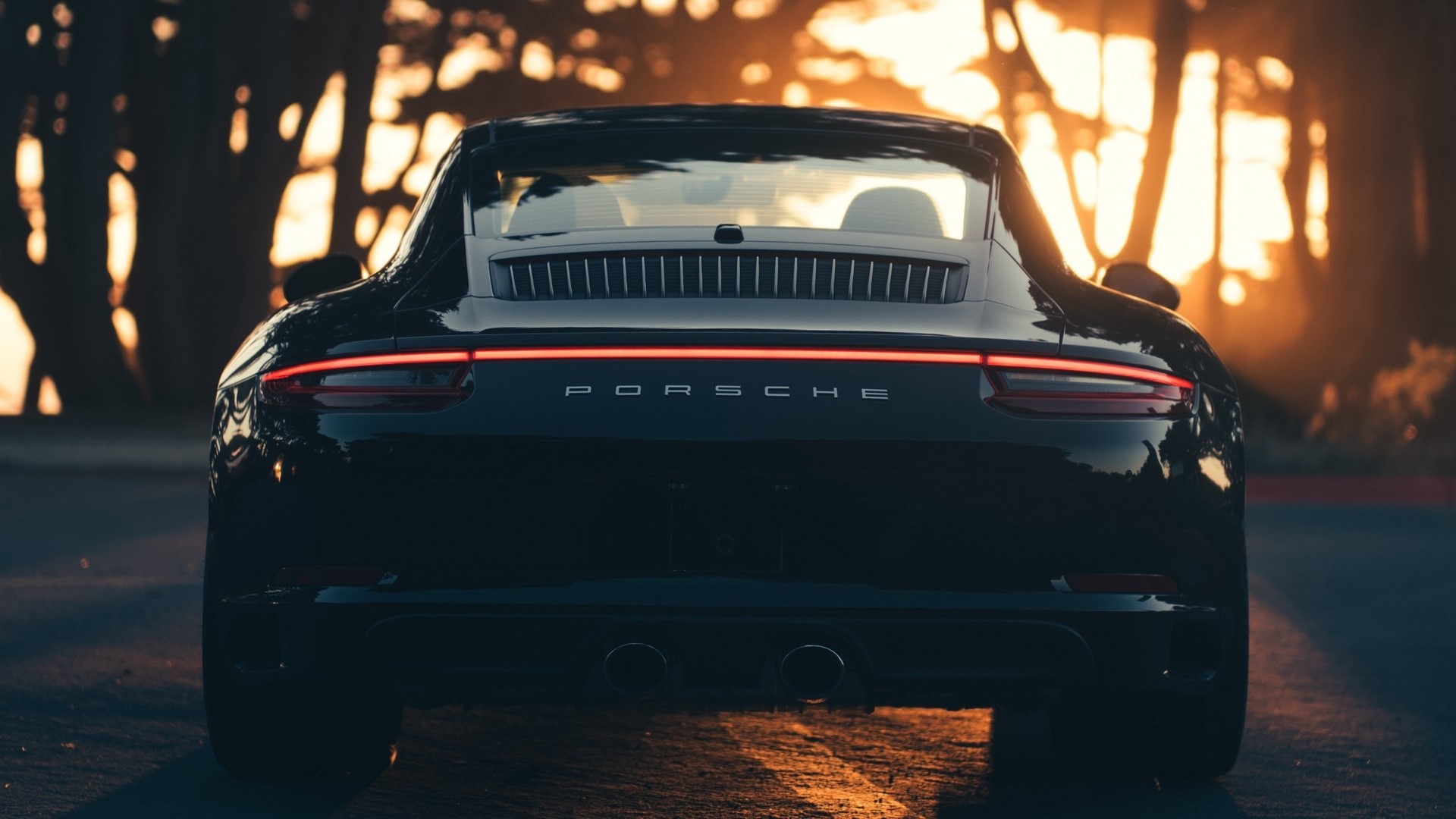 Rear view of a black Porsche car HD Wallpaper