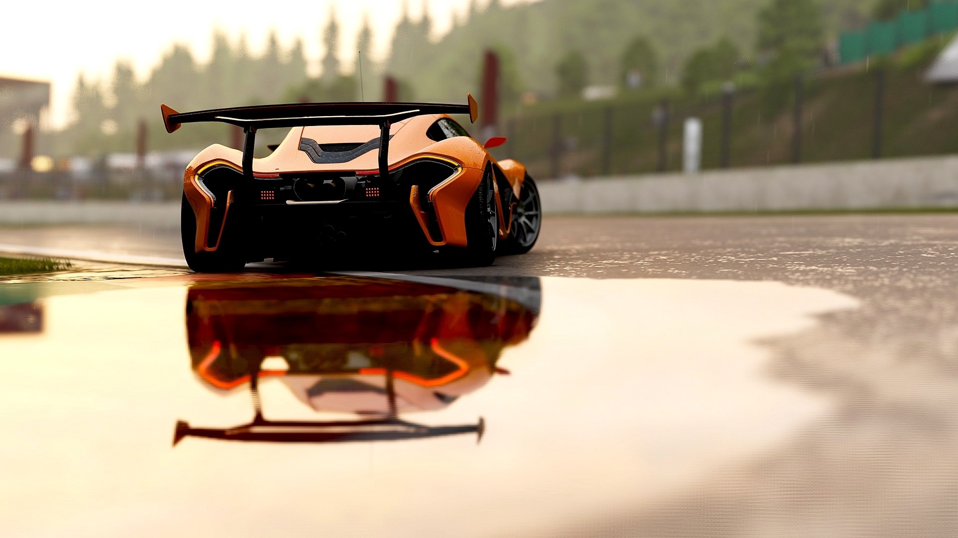 Orange McLaren P1 race car on wet track HD Wallpaper
