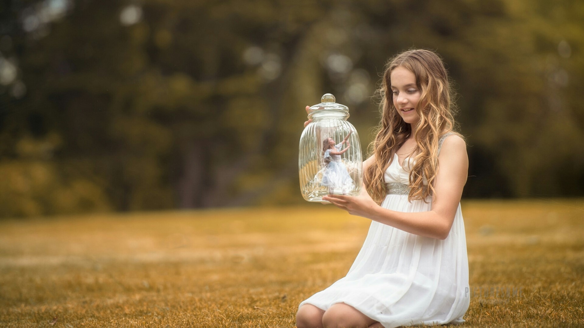 Girl holding a glass jar with a miniature dancer inside HD Wallpaper
