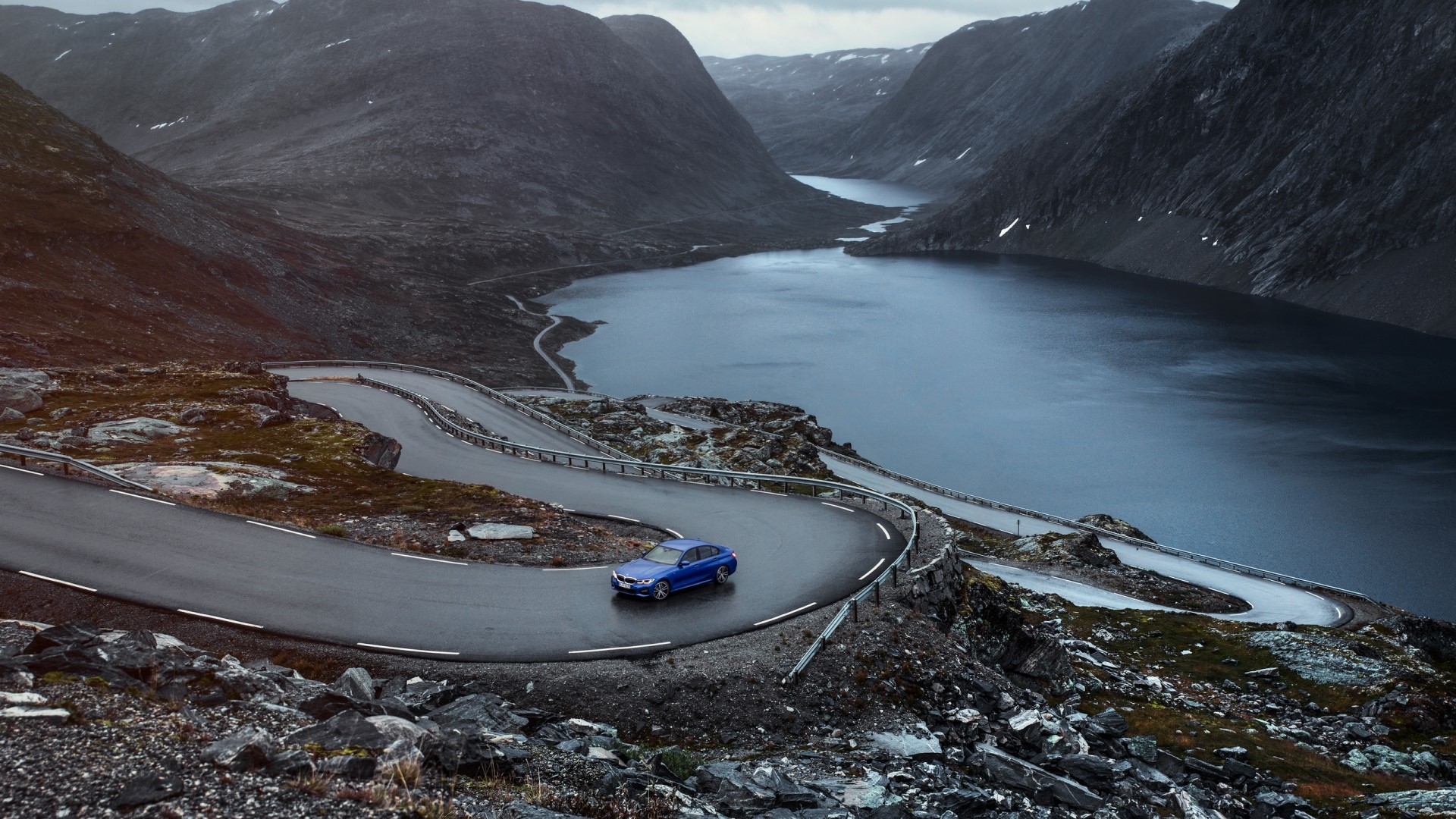 Blue BMW 3 Series G20 on a winding mountain road HD Wallpaper