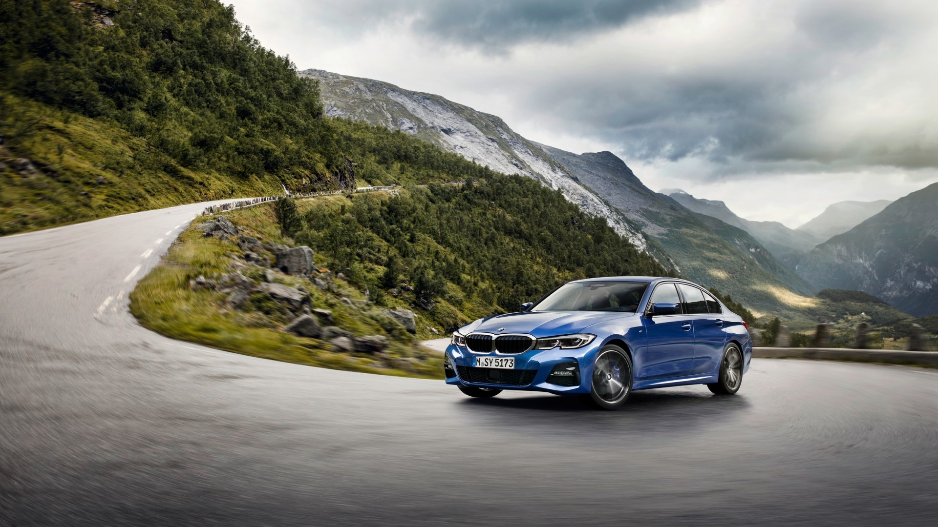 Blue BMW 3 Series G20 on a mountain road HD Wallpaper