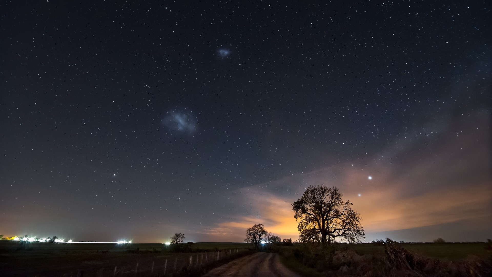Starry night sky over a rural landscape with trees HD Wallpaper