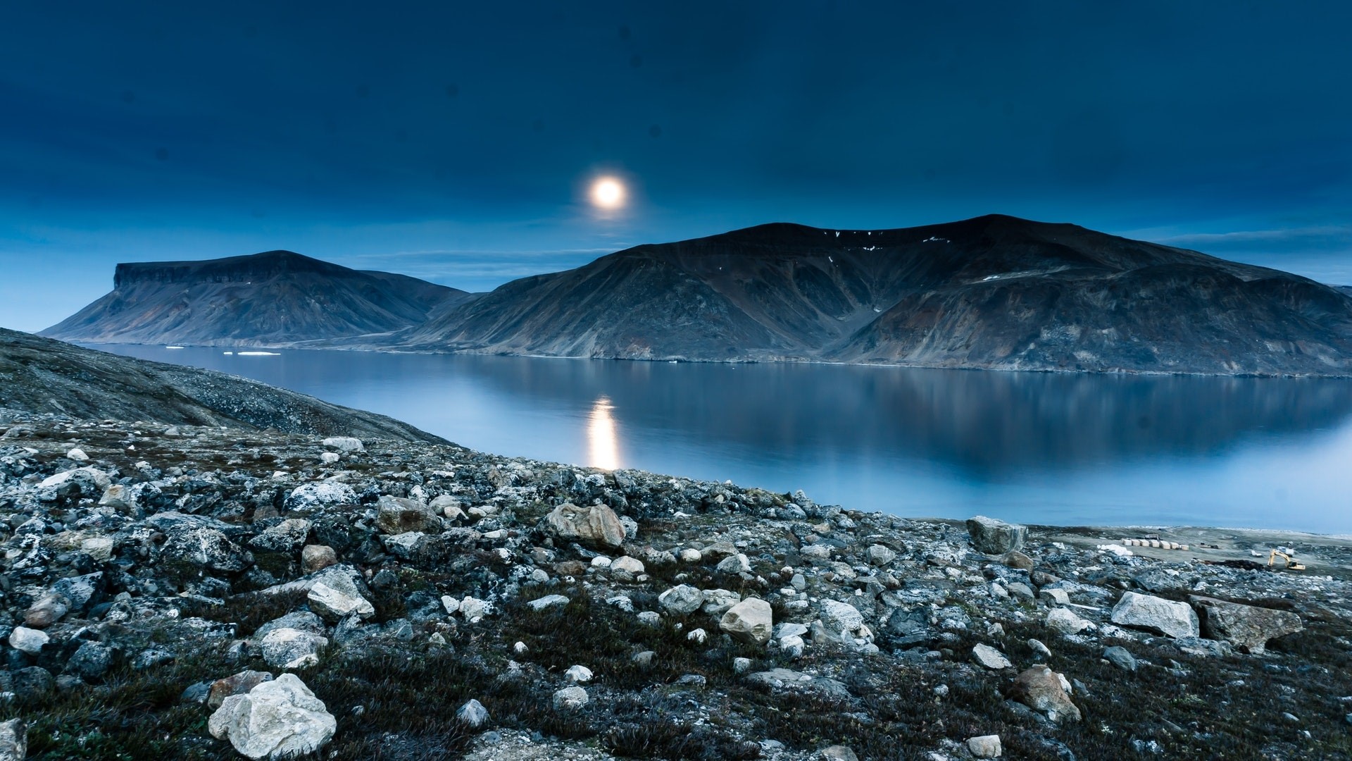 Moonlit lake and mountains with rocky foreground HD Wallpaper