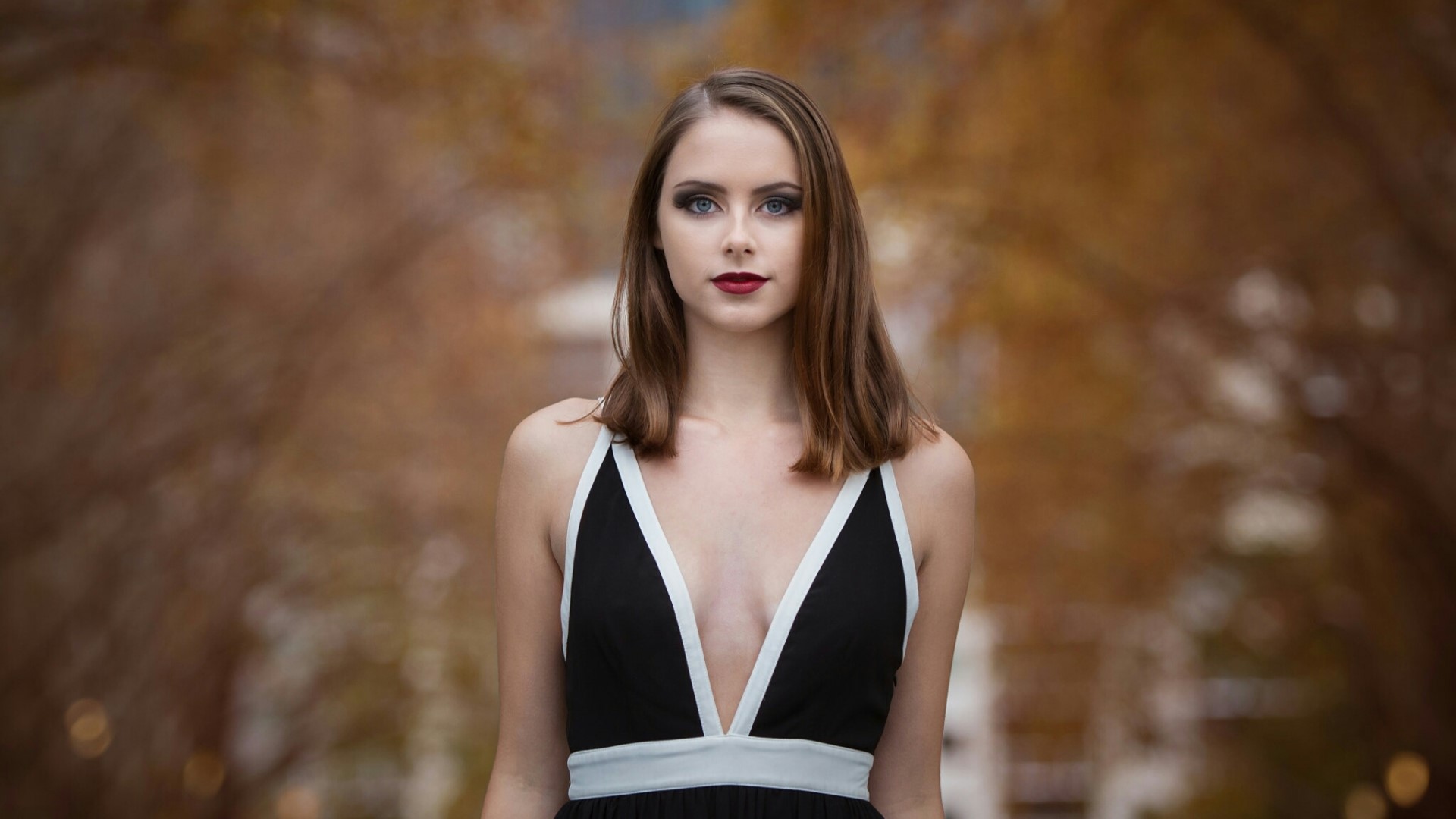 Woman in a black dress with white trim HD Wallpaper