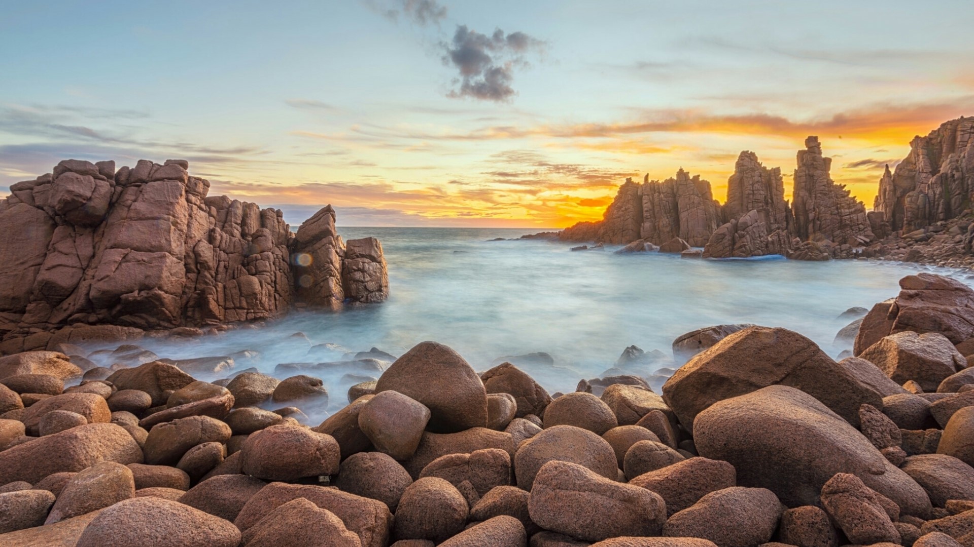 Rocky coastline with ocean at sunset HD Wallpaper