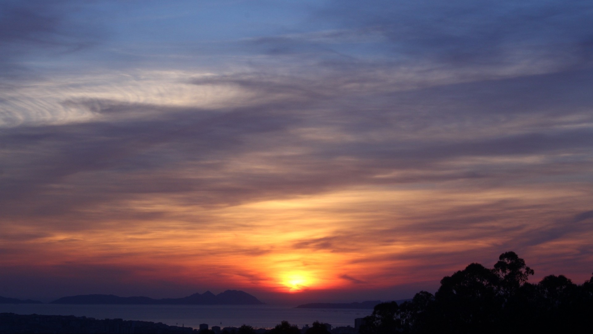 Sunset over the sea with clouds and trees HD Wallpaper