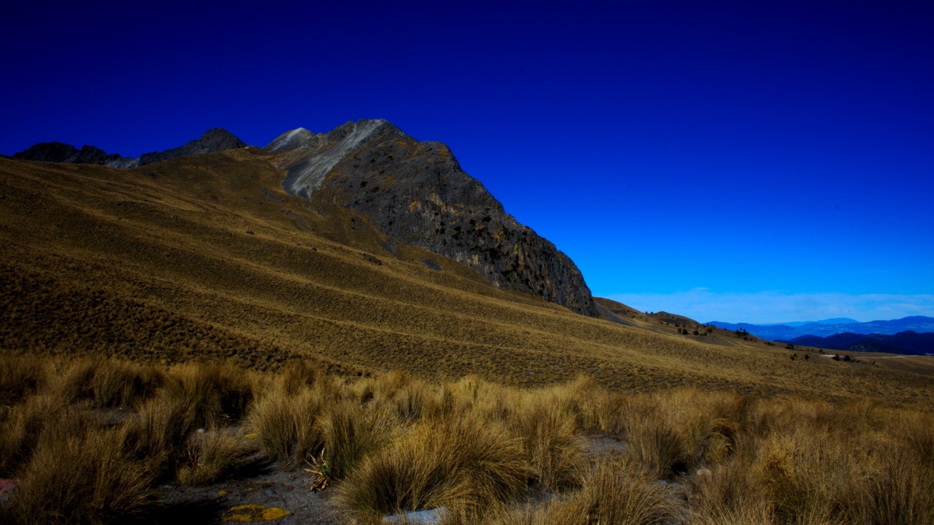 Mountain landscape with dry grass and blue sky in Mexico HD Wallpaper