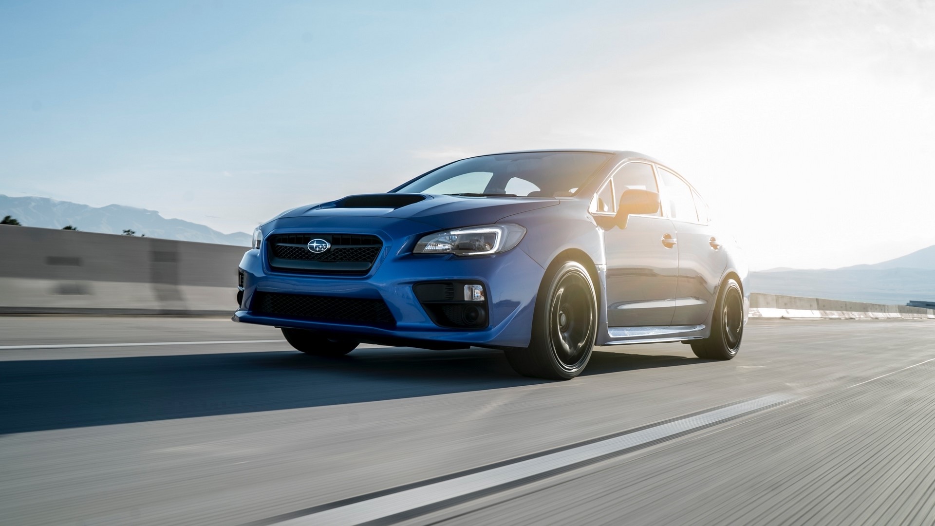 Blue Subaru WRX STI driving on a highway HD Wallpaper