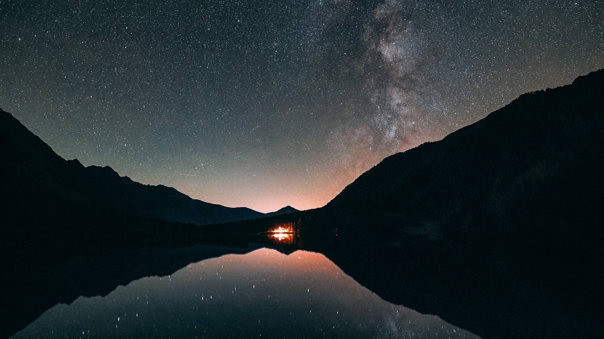 Starry night sky over a lake with mountains HD Wallpaper