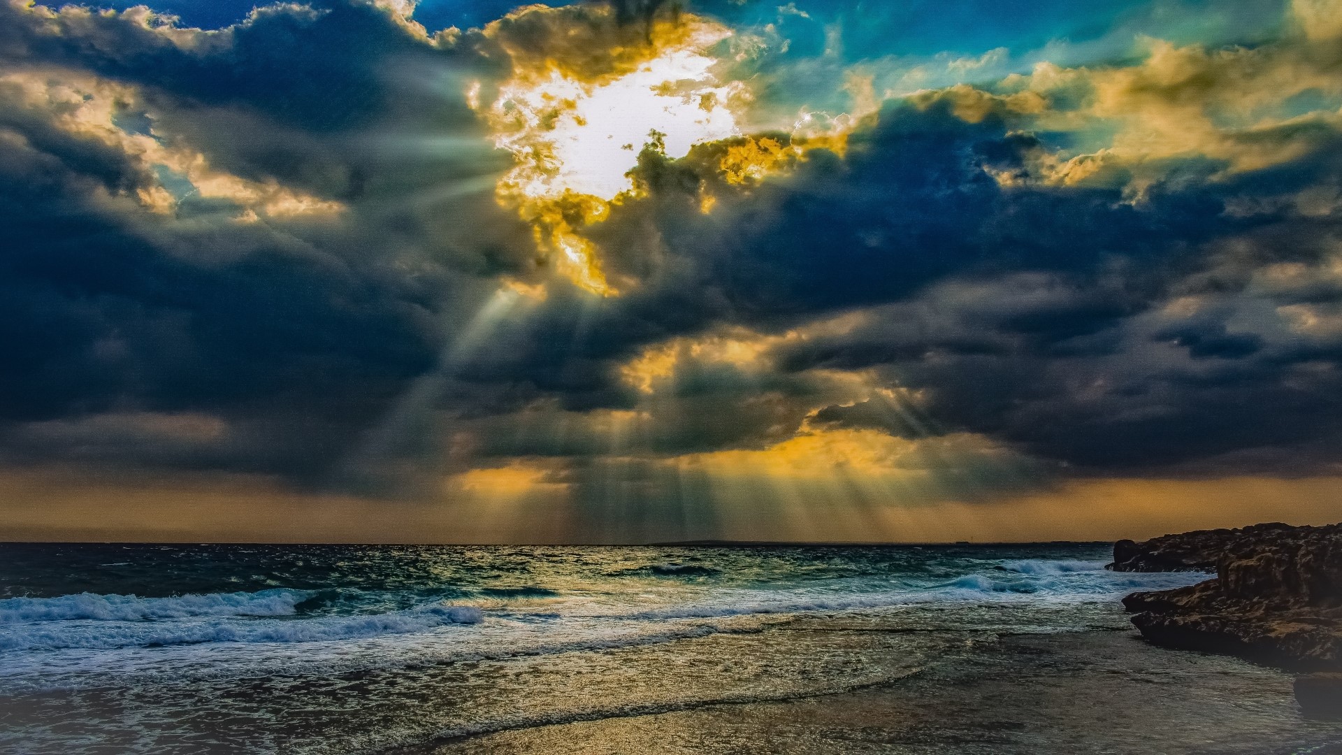 Sunbeams through clouds over the sea HD Wallpaper