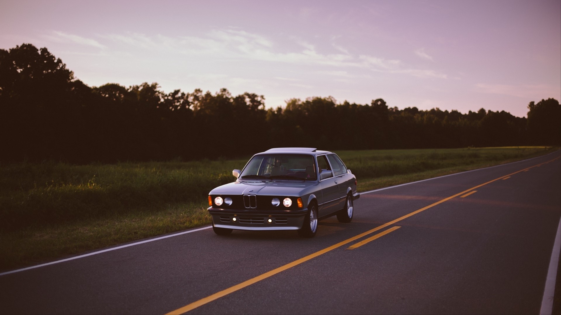 BMW car on a road at sunset HD Wallpaper