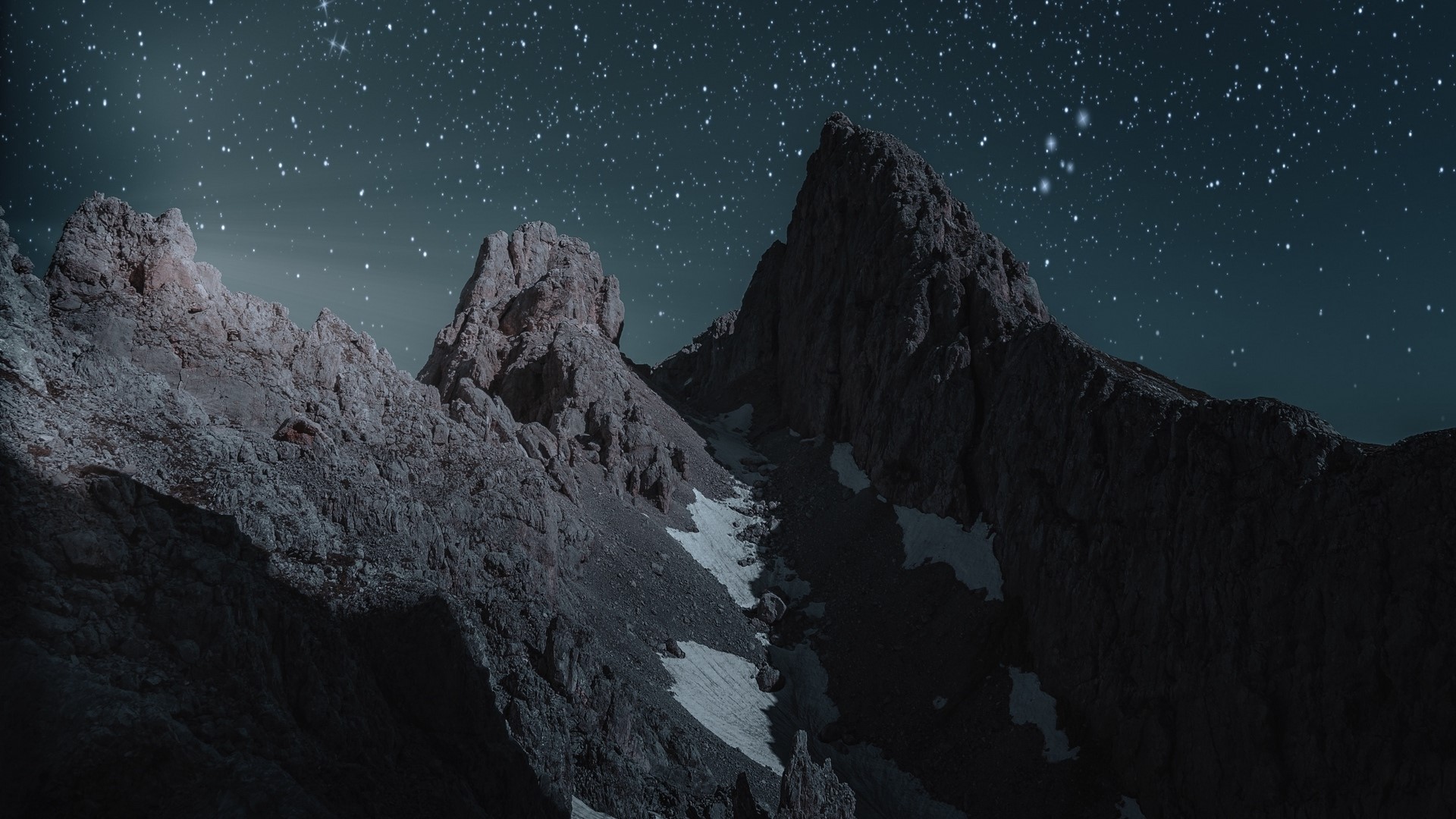 Mountain peaks under a starry night sky HD Wallpaper