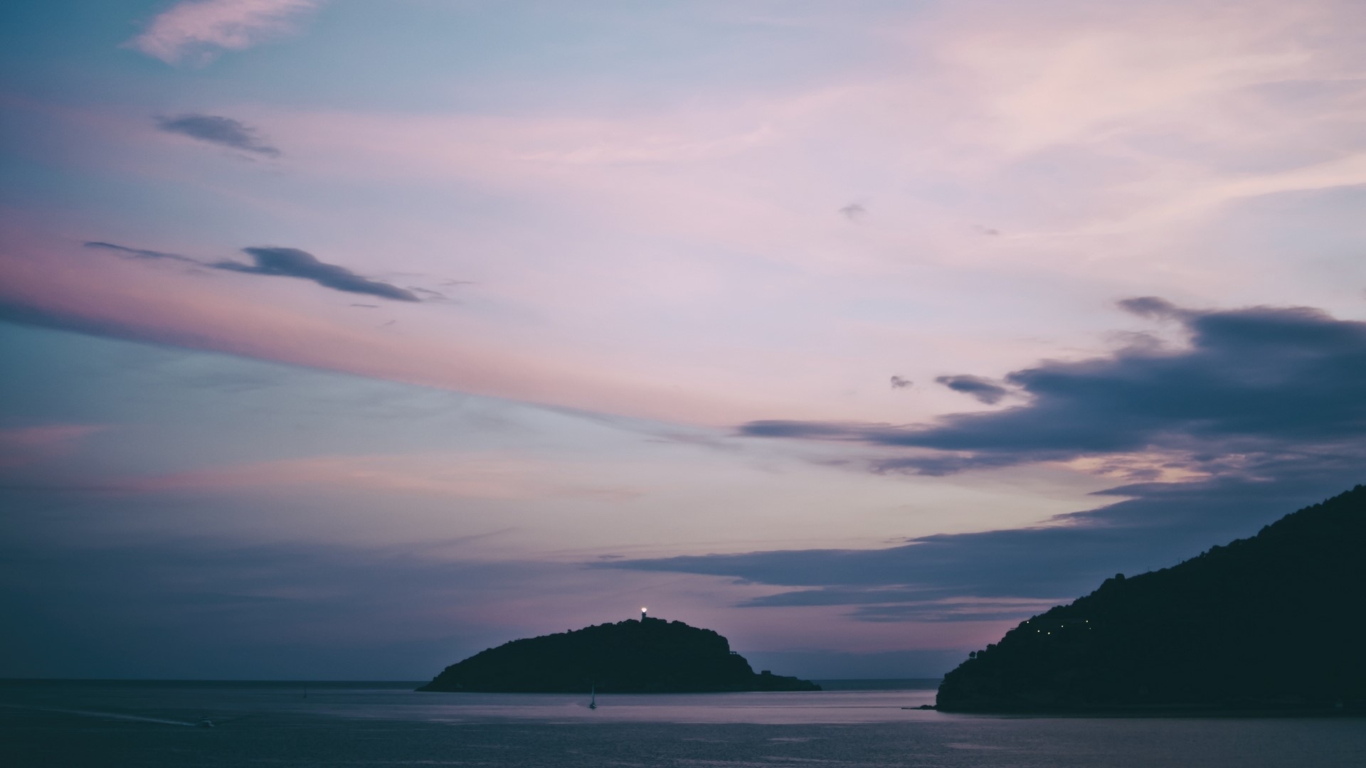 Islands at sunset with lighthouse HD Wallpaper