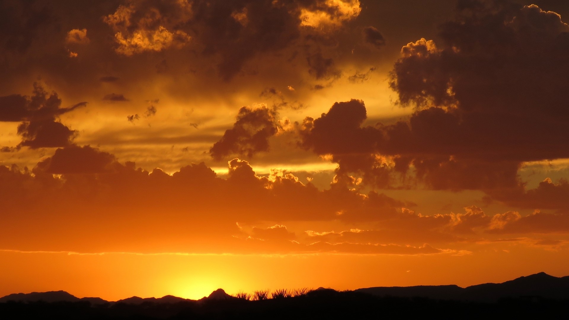 Sunset over mountains with dramatic clouds HD Wallpaper