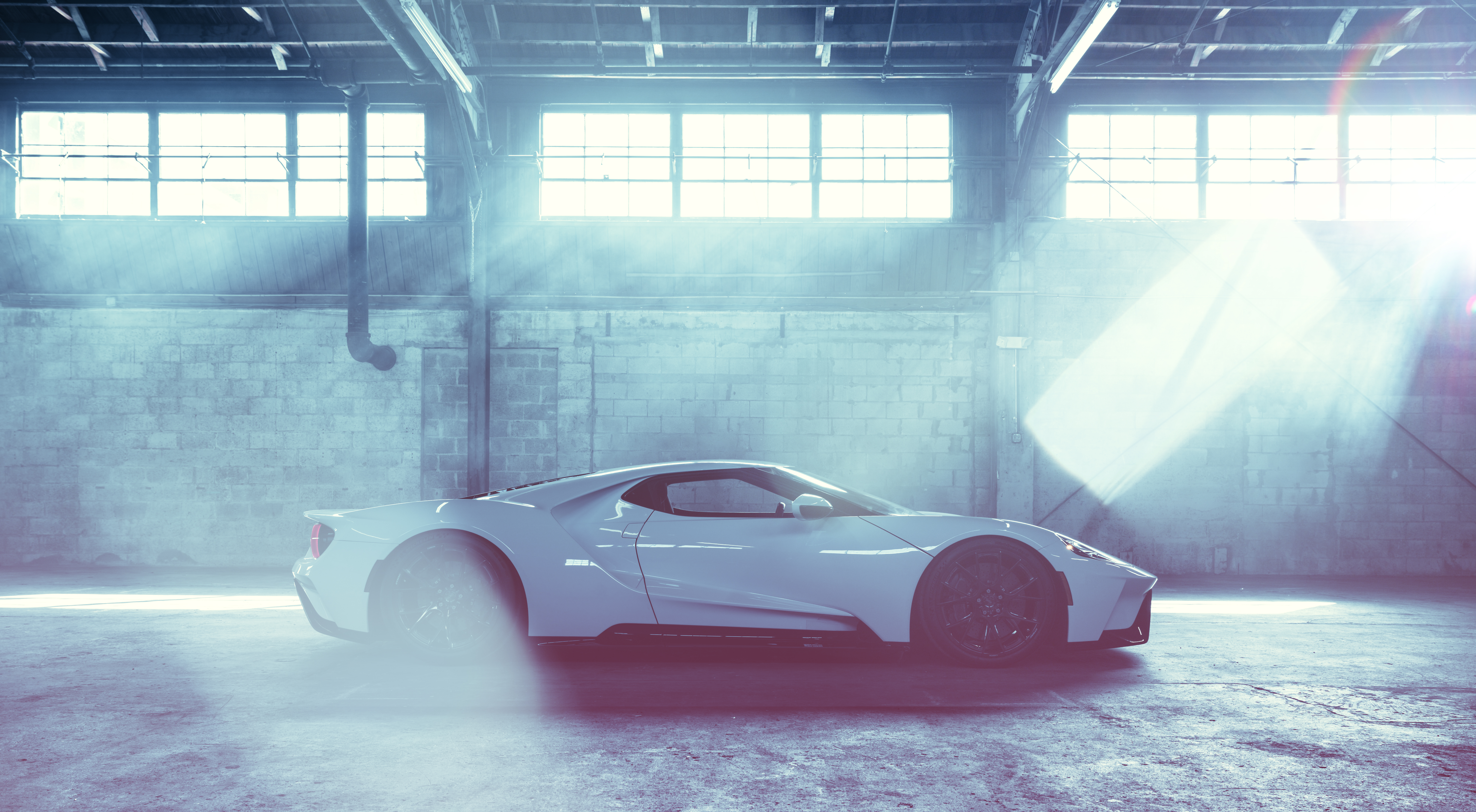 White Ford GT in a warehouse with smoke HD Wallpaper